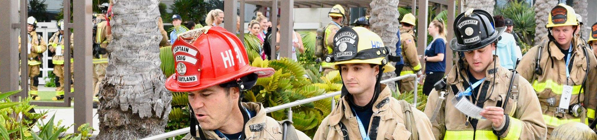 four firefighters are pictured at stair climb event walking in a row